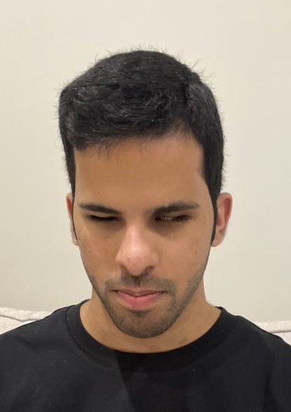 A portrait photo of Mohammed. He is wearing a black t-shirt and has short black hair.