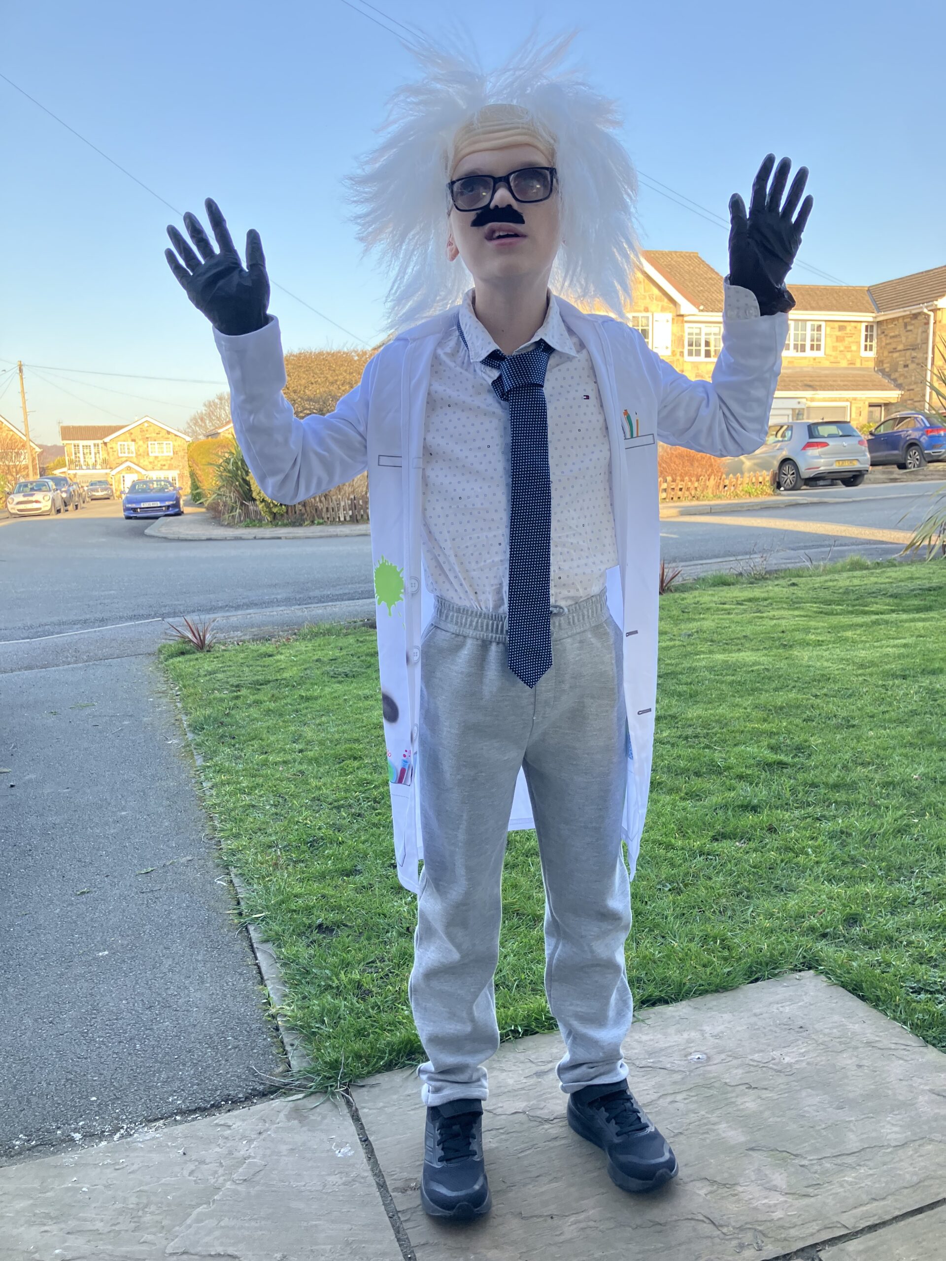 Benji Benji dressed as Einstein in a white lab coat and crazy wig.