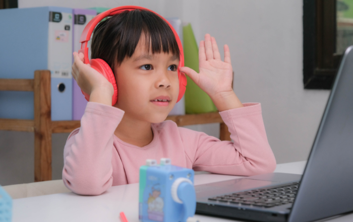 An image of a child wearing headphones looking into the distance.